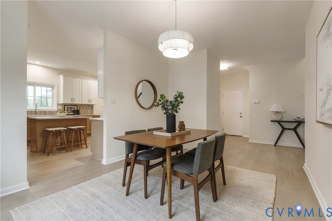 8060 Pebblepath Parkway, Hanover, VA 23111 Dining area featuring wood-finish flooring, a contemporary multi-tiered pendant light, and neutral wall tones