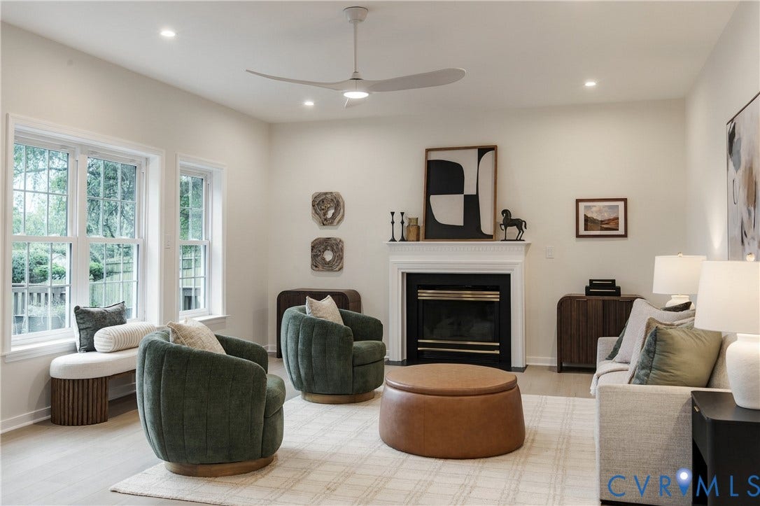 8060 Pebblepath Parkway, Hanover, VA 23111 Living area featuring a fireplace with a white mantel surround, large multi-pane windows, recessed lighting, a modern ceiling fan, and light-toned flooring