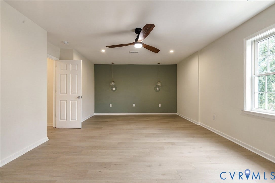 8060 Pebblepath Parkway, Hanover, VA 23111 Room featuring wood-finish flooring, accent wall, ceiling fan with integrated lighting, and dual glass pendant light fixtures