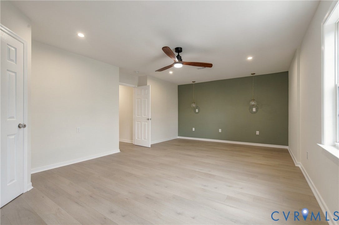 8060 Pebblepath Parkway, Hanover, VA 23111 Light-toned wood-finish flooring, accent wall, recessed lighting, ceiling fan with integrated light, and two suspended glass pendant lights