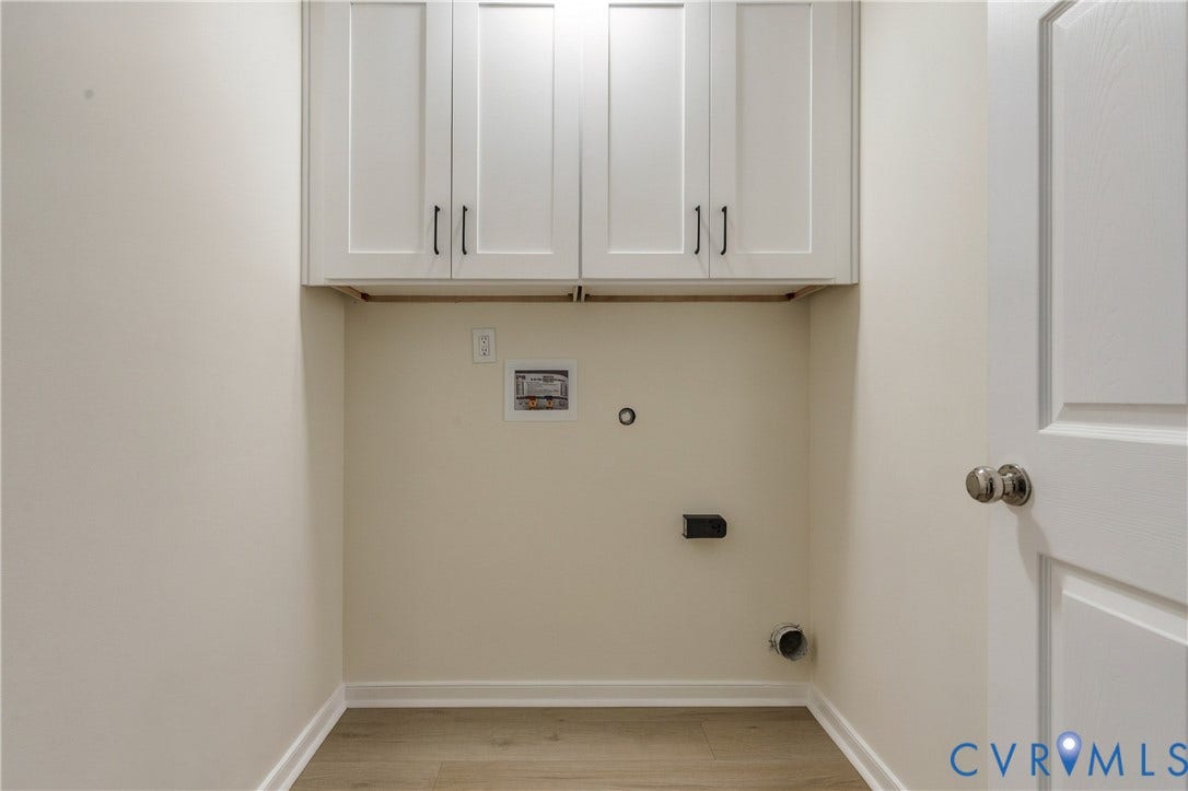 8060 Pebblepath Parkway, Hanover, VA 23111 Utility area featuring white shaker-style wall cabinetry with dark hardware and wood-finish flooring