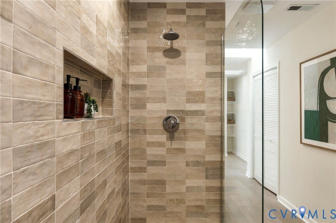 8060 Pebblepath Parkway, Hanover, VA 23111 Walk-in shower featuring textured ceramic wall tile, a built-in recessed wall niche, a glass enclosure, and metallic fixed-head plumbing fixtures