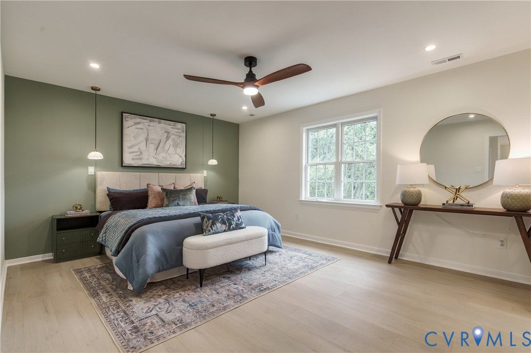 8060 Pebblepath Parkway, Hanover, VA 23111 Room featuring light wood-finish flooring, a sage green accent wall, dual pendant light fixtures, and a ceiling fan