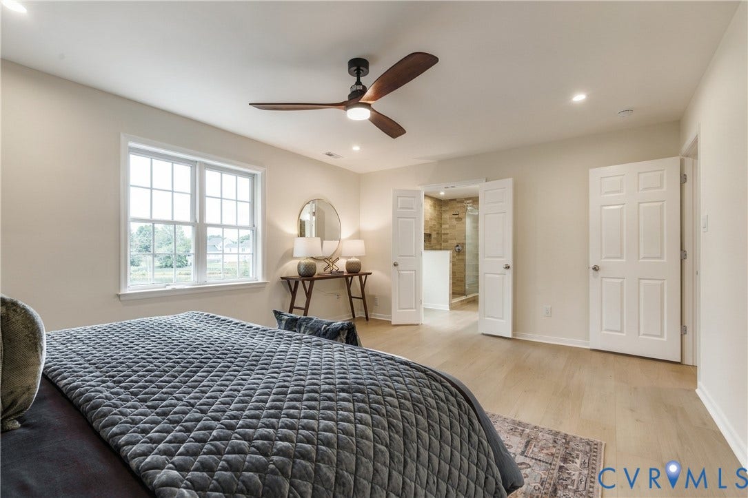 8060 Pebblepath Parkway, Hanover, VA 23111 Spacious room featuring light wood-finish flooring, recessed lighting, and a modern ceiling fan with dark wood-tone blades