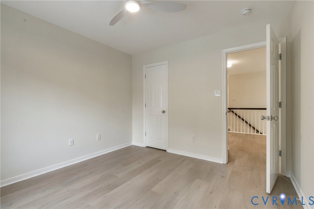 8060 Pebblepath Parkway, Hanover, VA 23111 Neutral interior with wood-finish flooring, white paneled doors, and a ceiling-mounted light fixture with an integrated fan