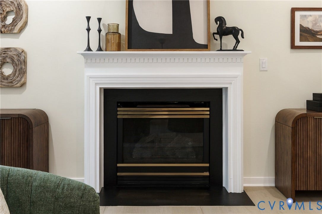 8060 Pebblepath Parkway, Hanover, VA 23111 Fireplace featuring a white decorative mantel with dentil molding, black metal surround, and a metal firebox insert