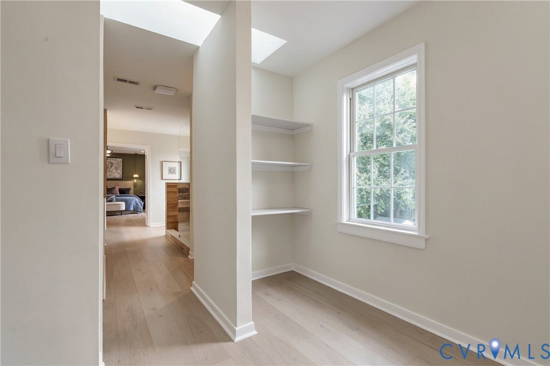 8060 Pebblepath Parkway, Hanover, VA 23111 Interior space featuring wood-finish flooring, dual skylights, built-in shelving, and a multi-pane window