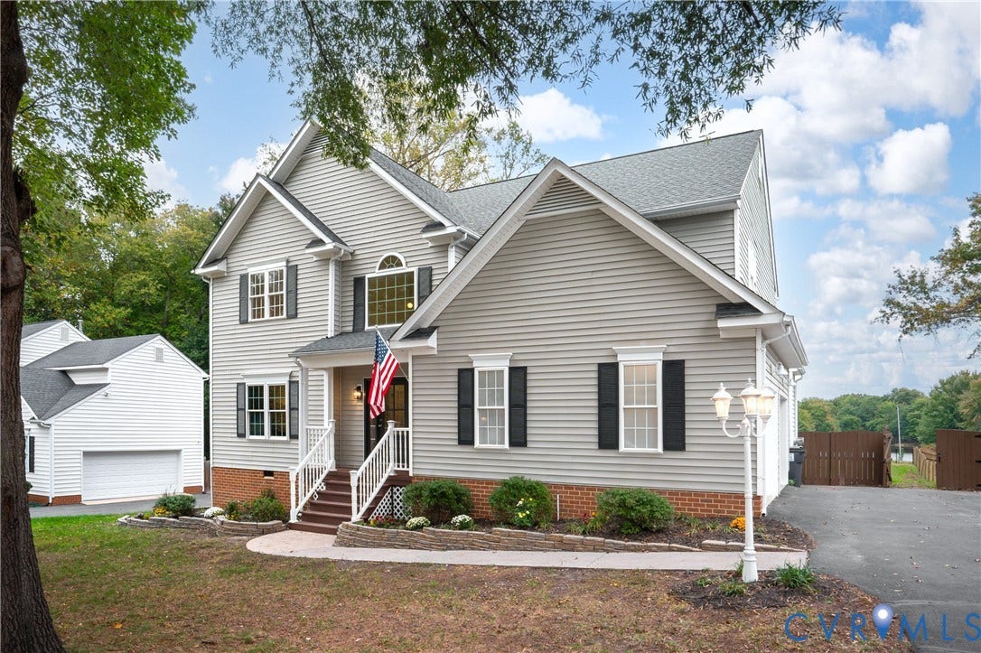 8060 Pebblepath Parkway, Hanover, VA 23111 Two-story exterior featuring horizontal siding, brick veneer foundation, multi-gabled roofline, decorative shutters, and an elevated front porch