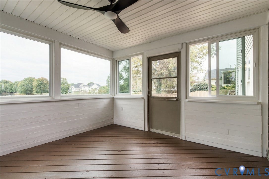 8060 Pebblepath Parkway, Hanover, VA 23111 Enclosed porch featuring wood-finish decking, white horizontal shiplap wall paneling, large sliding windows, and an overhead ceiling fan