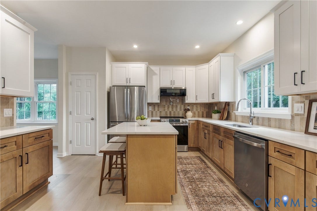 8060 Pebblepath Parkway, Hanover, VA 23111 Kitchen featuring two-tone shaker-style cabinetry, quartz countertops, stainless steel appliances, a center island with counter seating, and wood-finish flooring