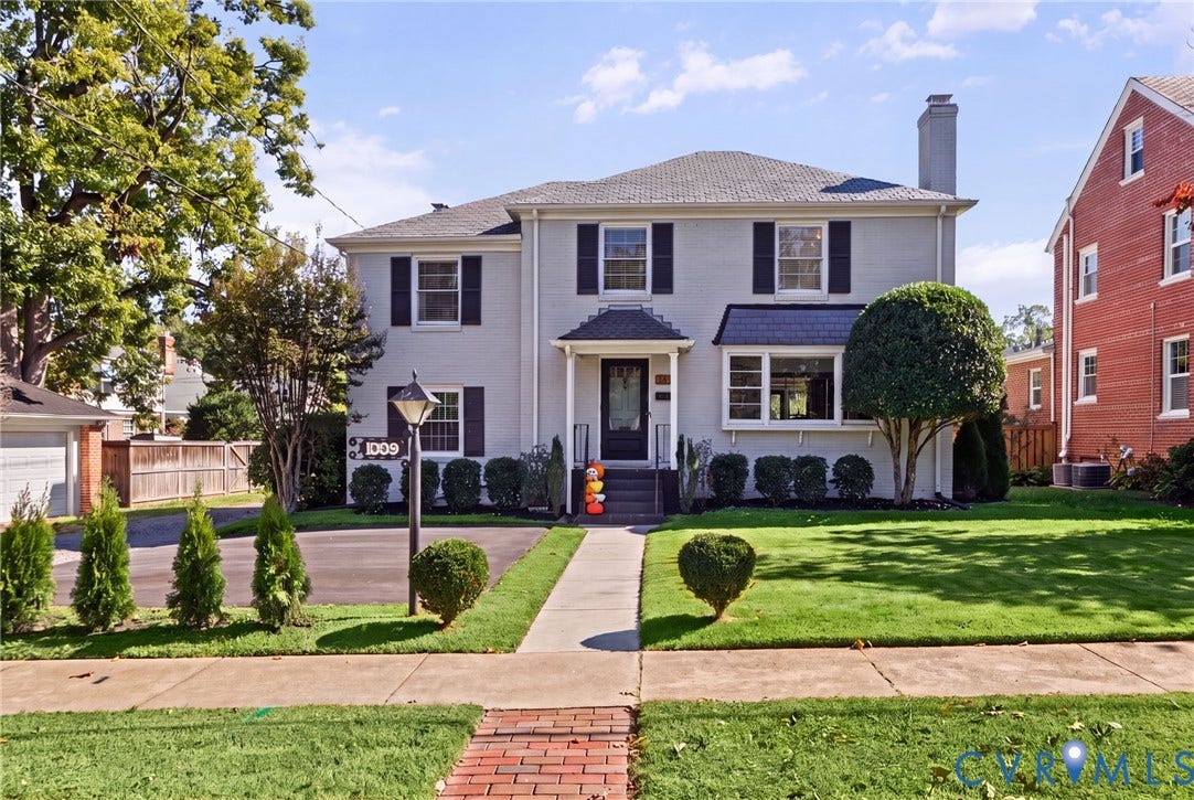 1009 Malvern Avenue, Malvern Gardens, Richmond, VA 23221 Painted brick exterior featuring dark shutters, a covered front entryway, a chimney, and a landscaped front lawn