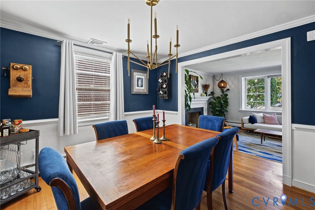 1009 Malvern Avenue, Malvern Gardens, Richmond, VA 23221 Dining area featuring wood-finish flooring, chair rail molding, a multi-arm candle-style chandelier, and a fireplace with a wood mantel