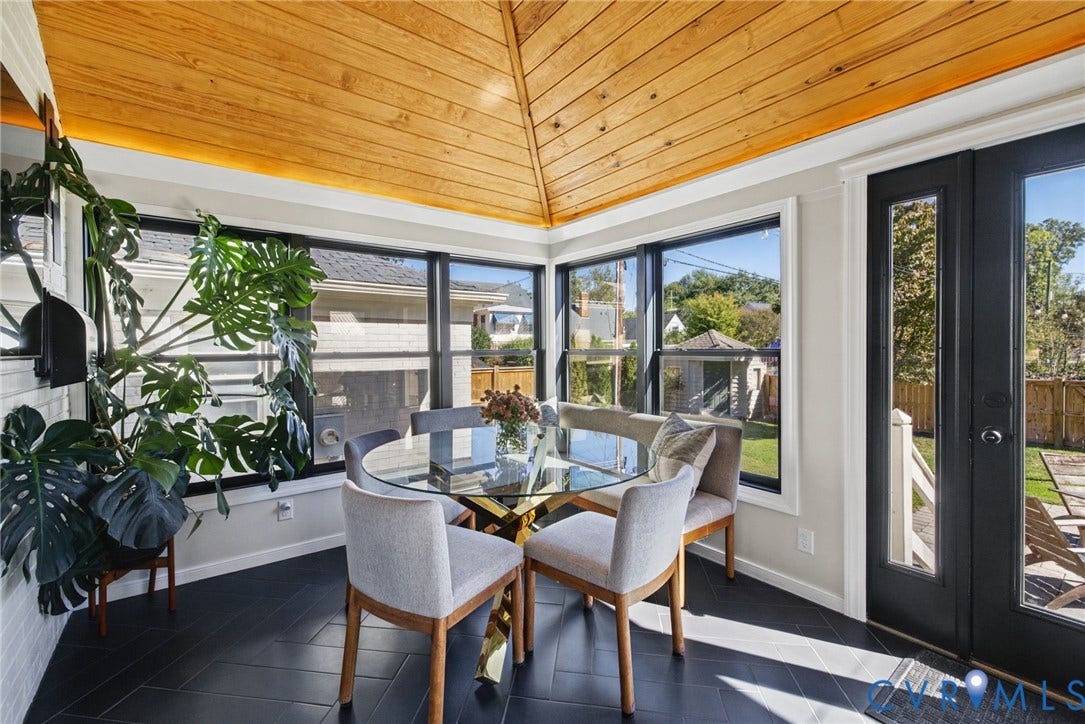 1009 Malvern Avenue, Malvern Gardens, Richmond, VA 23221 Sunroom featuring a vaulted natural wood-plank ceiling, dark herringbone-patterned flooring, wrap-around windows with black framing, and a full-lite glass exterior door