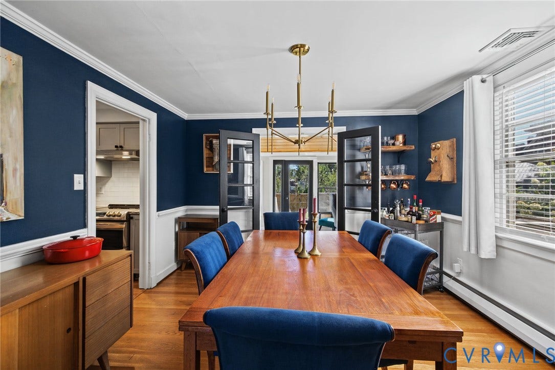 1009 Malvern Avenue, Malvern Gardens, Richmond, VA 23221 Dining room featuring wood-finish flooring, deep-tone wall paint, waist-height wainscoting, an overhead metal chandelier, and double French doors with glass panes