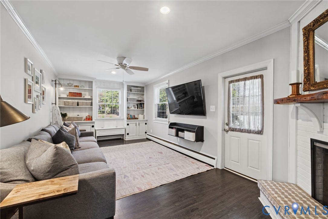 1009 Malvern Avenue, Malvern Gardens, Richmond, VA 23221 Living area featuring wood-finish flooring, built-in floor-to-ceiling cabinetry, recessed lighting, ceiling fan, and a fireplace with a rustic mantel