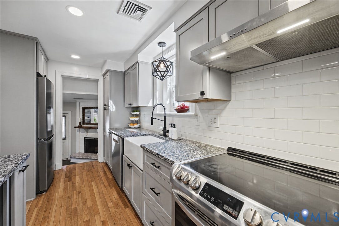 1009 Malvern Avenue, Malvern Gardens, Richmond, VA 23221 Kitchen featuring gray shaker-style cabinetry, white subway tile backsplash, farmhouse sink with matte black faucet, and stainless steel appliances