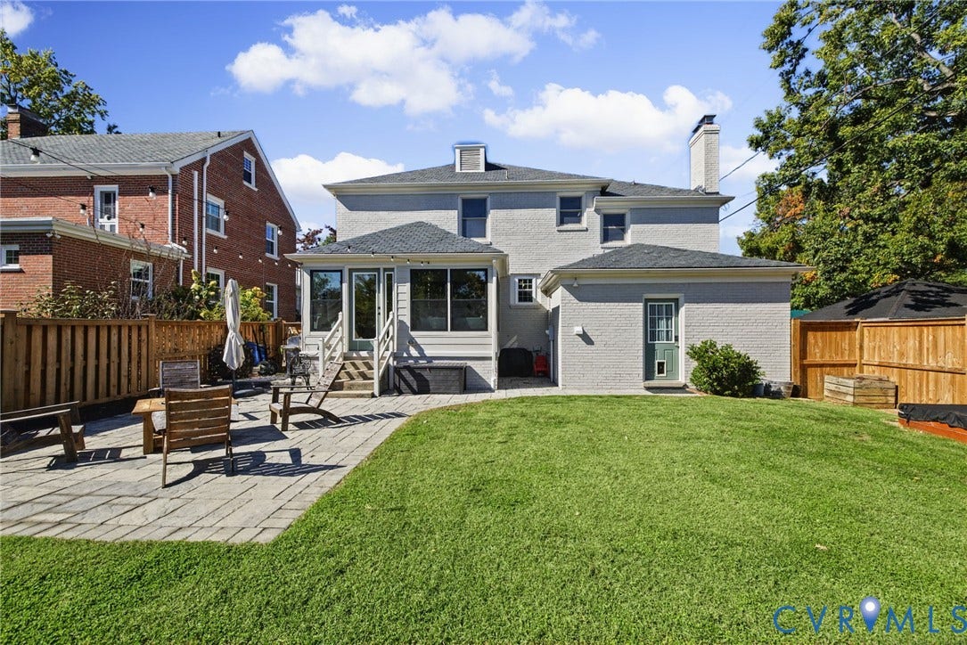 1009 Malvern Avenue, Malvern Gardens, Richmond, VA 23221 Backyard featuring a paved stone patio, manicured lawn, painted masonry exterior, and wooden privacy fencing