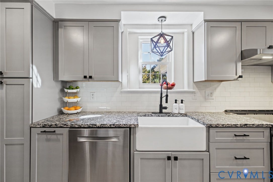 1009 Malvern Avenue, Malvern Gardens, Richmond, VA 23221 Kitchen featuring grey shaker-style cabinetry, white subway tile backsplash, stone-surface countertops, white apron-front farmhouse sink, and matte black hardware