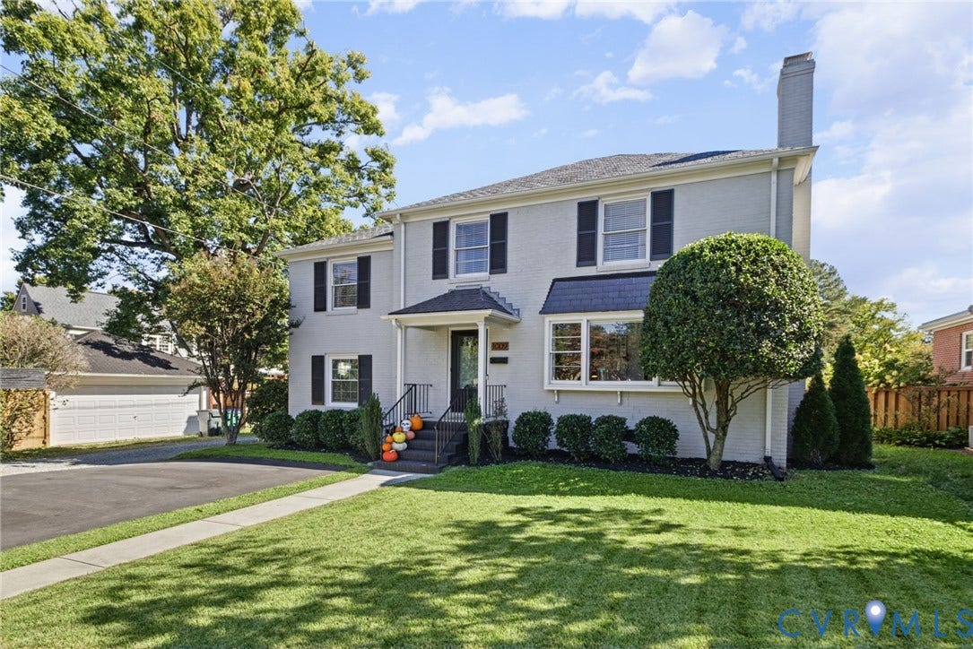 1009 Malvern Avenue, Malvern Gardens, Richmond, VA 23221 Two-story traditional exterior featuring light-toned brick masonry, black shutters, an asphalt shingle roof, a covered front entryway, and a paved driveway