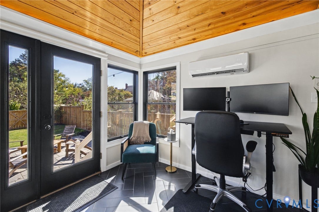 1009 Malvern Avenue, Malvern Gardens, Richmond, VA 23221 Vaulted wood-plank ceiling, black-framed glass entry door, herringbone-patterned tile flooring, multiple windows, and wall-mounted HVAC unit