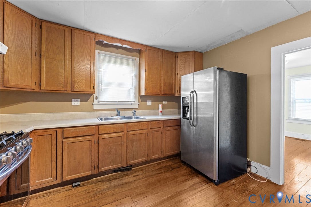 13530 Richmond Road, Village, Warsaw, VA 22572 Kitchen featuring wood cabinets, pine floors, double sinks, self standing island & gas range.
