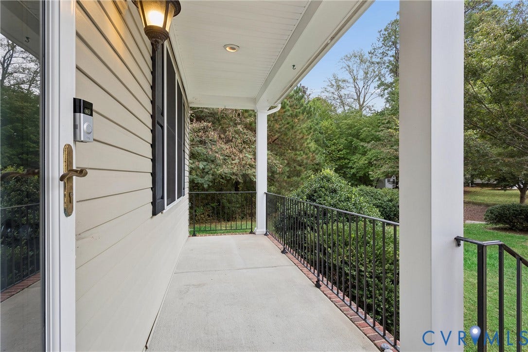 Covered porch featuring concrete flooring, black metal railing, beadboard ceiling with recessed lighting, and a wall-mounted exterior sconce