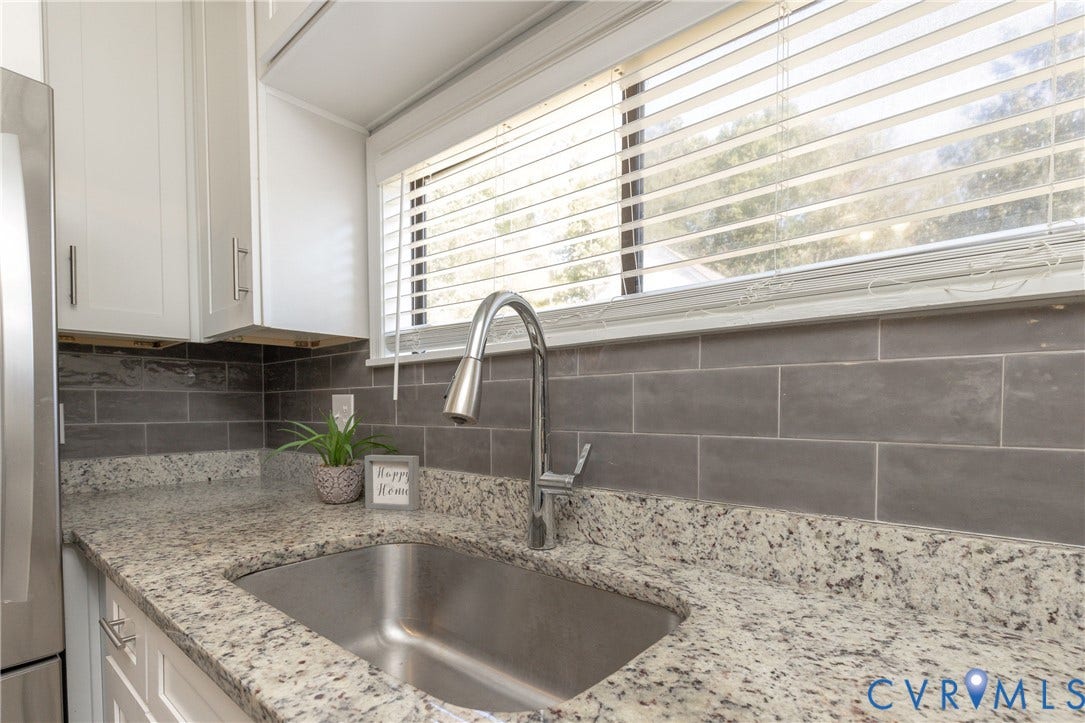 3705 Yard Arm Drive, Chesterfield, VA 23831 Kitchen featuring stone countertops, stainless steel undermount sink, gooseneck faucet, gray subway tile backsplash, and white cabinetry