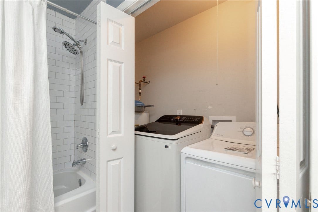3705 Yard Arm Drive, Chesterfield, VA 23831 Subway tile shower surround with a dual-head shower fixture, polished chrome hardware, and an integrated laundry closet