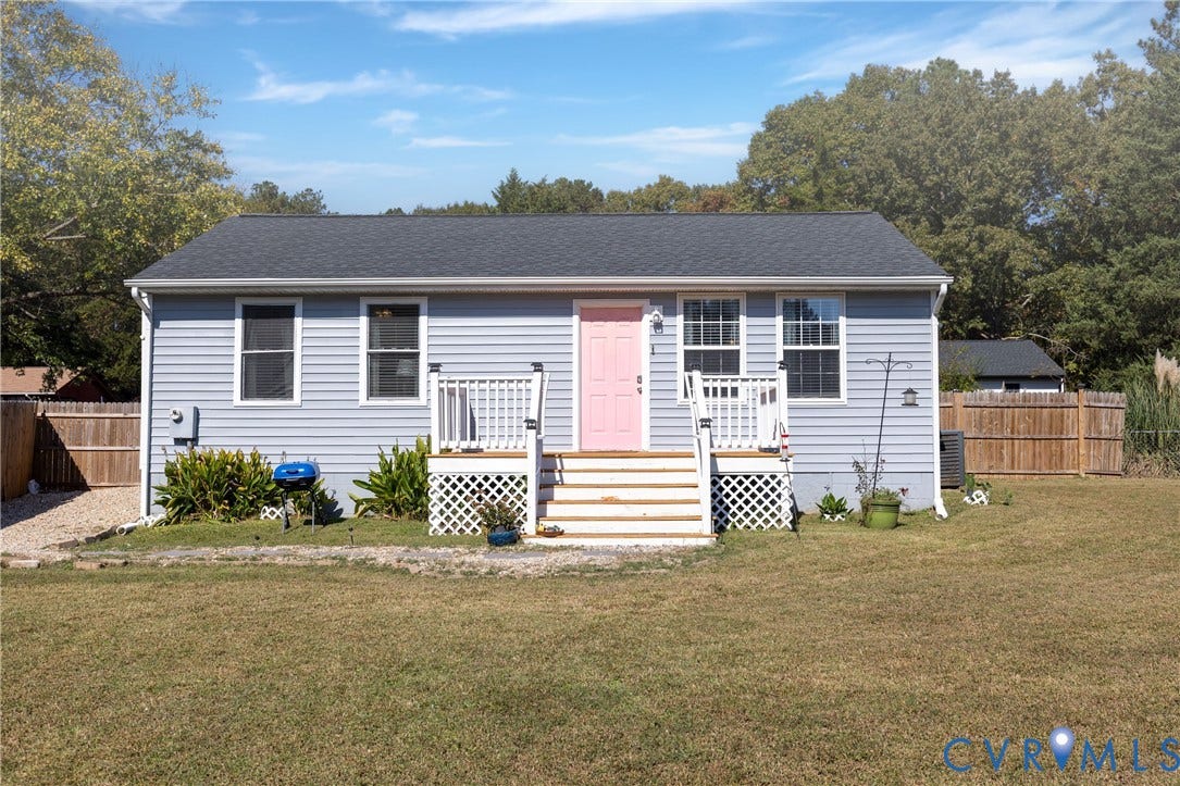 3705 Yard Arm Drive, Chesterfield, VA 23831 Single-story home featuring light-blue vinyl siding, a dark-tone shingled roof, a wooden front deck with lattice skirting, and a fenced exterior perimeter