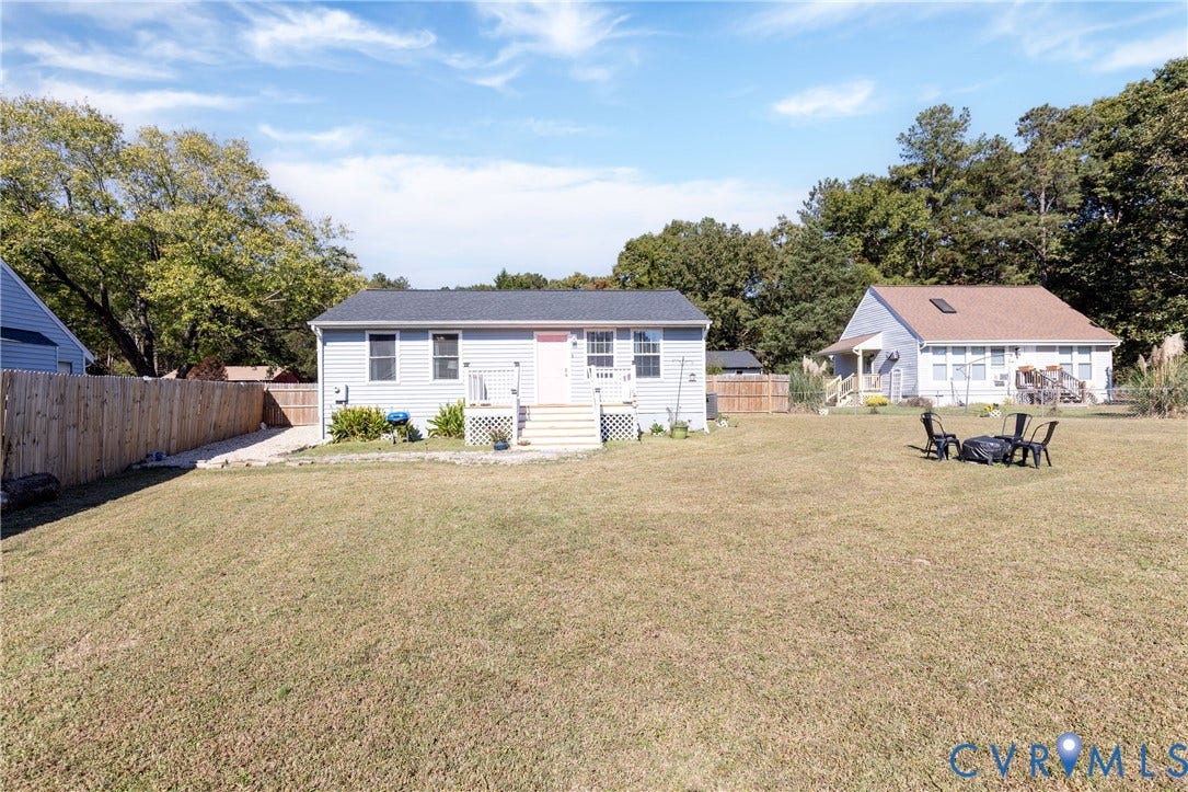 3705 Yard Arm Drive, Chesterfield, VA 23831 Single-story residence featuring light-colored horizontal siding, a pitched asphalt shingle roof, a raised entry deck with stairs, and an expansive fenced backyard