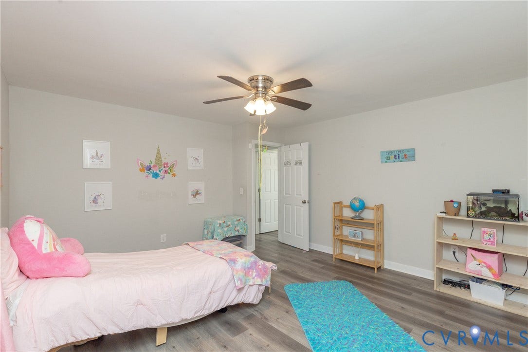3705 Yard Arm Drive, Chesterfield, VA 23831 Neutral-toned interior featuring wood-finish flooring, a multi-blade ceiling fan with integrated lighting, and a paneled interior door
