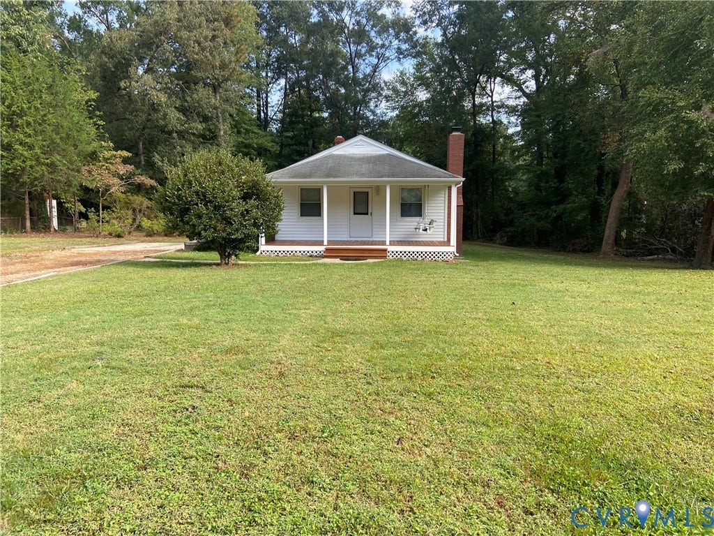8358 Patrick Henry Boulevard, Mechanicsville, VA 23116 Exterior facade featuring white siding, a covered front porch with wooden steps, a gable roof, and a brick chimney