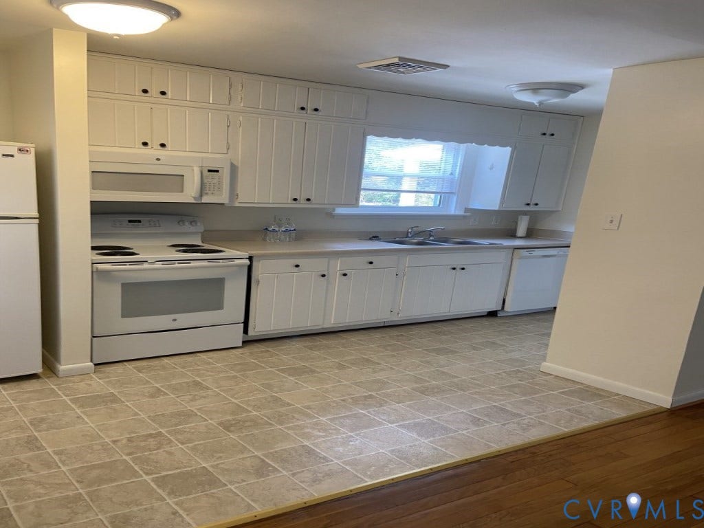 8358 Patrick Henry Boulevard, Mechanicsville, VA 23116 Kitchen featuring white cabinetry, solid-surface countertops, dual-basin sink, integrated white appliances, and tiled flooring