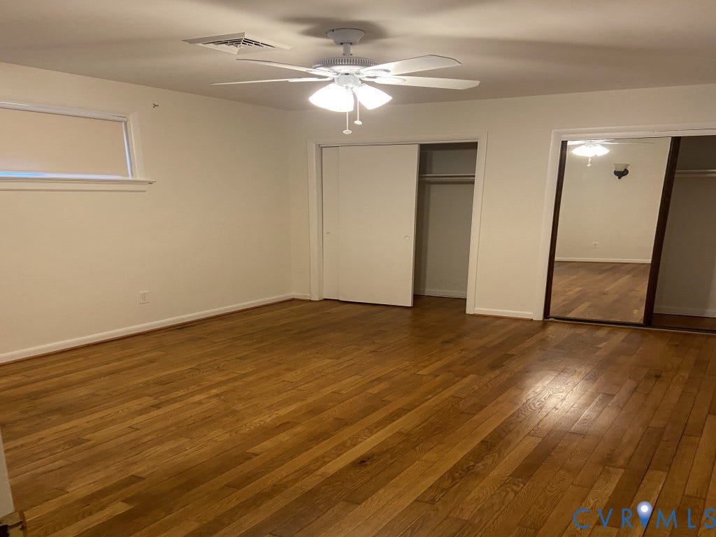 8358 Patrick Henry Boulevard, Mechanicsville, VA 23116 Wood-finish flooring, ceiling fan with integrated lighting, closet with sliding panels, and a closet with mirrored sliding doors