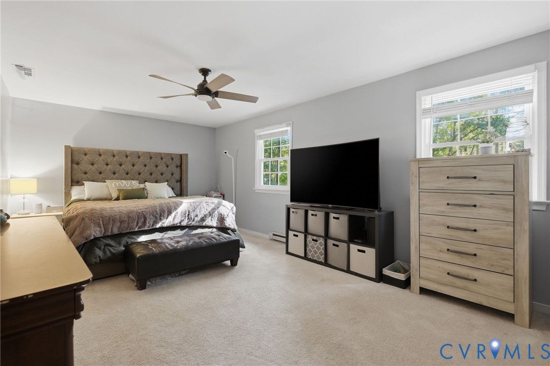 2764 Birdsong Lane, Powhatan, VA 23139 Spacious primary bedroom on second floor room featuring neutral carpeting, a ceiling fan, and multiple windows