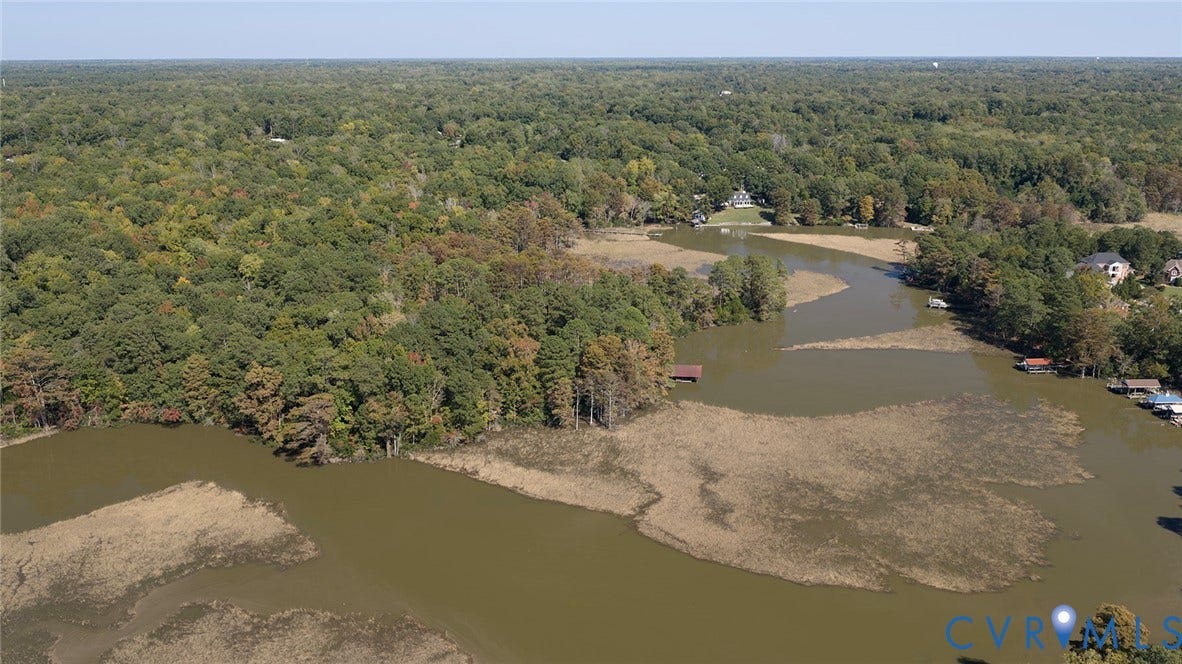 234 Sandy Bay Road, Williamsburg, VA 23185 Aerial perspective featuring extensive waterfront access, marshland topography, and abundant mature woodland foliage