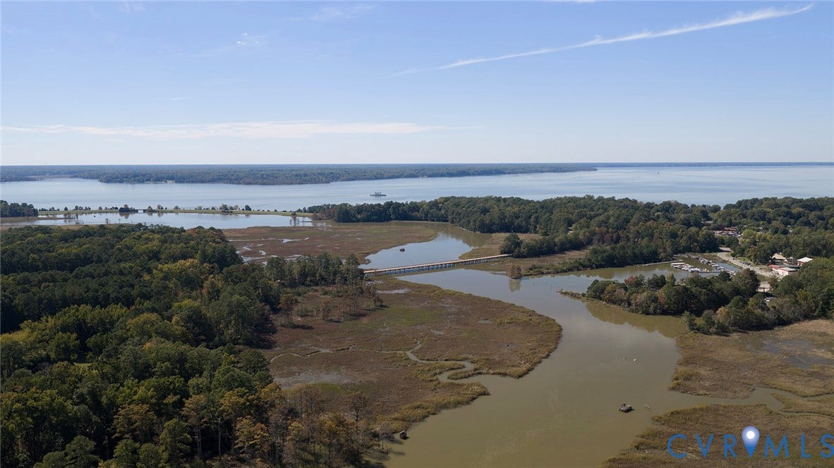 234 Sandy Bay Road, Williamsburg, VA 23185 Aerial perspective featuring expansive tidal marshland, wooded acreage, and coastal waterfront access
