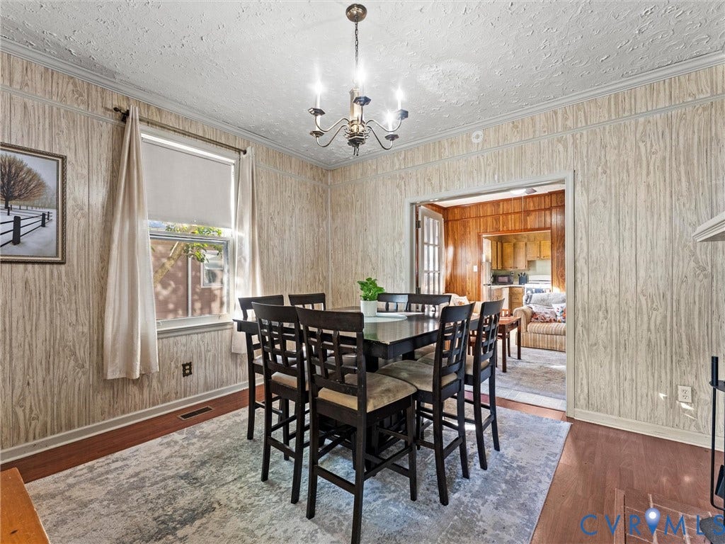 124 Suffolk Avenue, Chesterfield Highlands, Colonial Heights, VA 23834 Wood-paneling wall finishes, multi-light chandelier, and wood-finish flooring