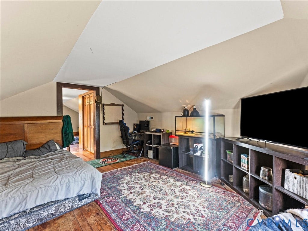 124 Suffolk Avenue, Chesterfield Highlands, Colonial Heights, VA 23834 Bedroom featuring vaulted ceilings, dark-stained wood trim, and wood flooring