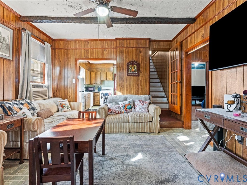 124 Suffolk Avenue, Chesterfield Highlands, Colonial Heights, VA 23834 Living area featuring wood-paneled walls, exposed ceiling beams, and a mounted ceiling fan