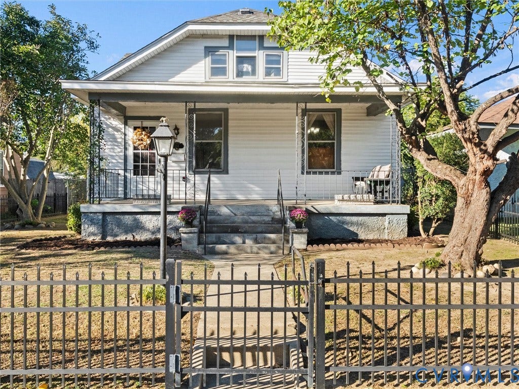 124 Suffolk Avenue, Chesterfield Highlands, Colonial Heights, VA 23834 Bungalow residence featuring a covered front porch, horizontal siding, a concrete pathway, and an ornamental metal perimeter fence