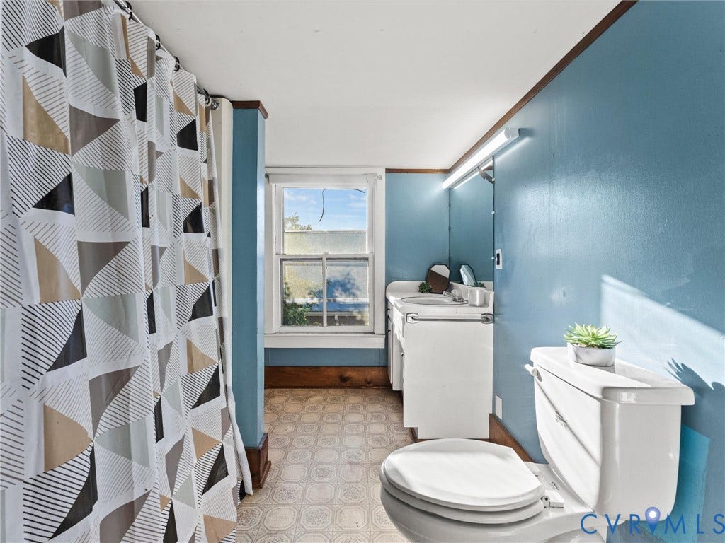 124 Suffolk Avenue, Chesterfield Highlands, Colonial Heights, VA 23834 Bathroom featuring a white vanity cabinet with an integrated sink, wall-mounted vanity lighting, a large mirror, a multi-pane window, and patterned resilient flooring