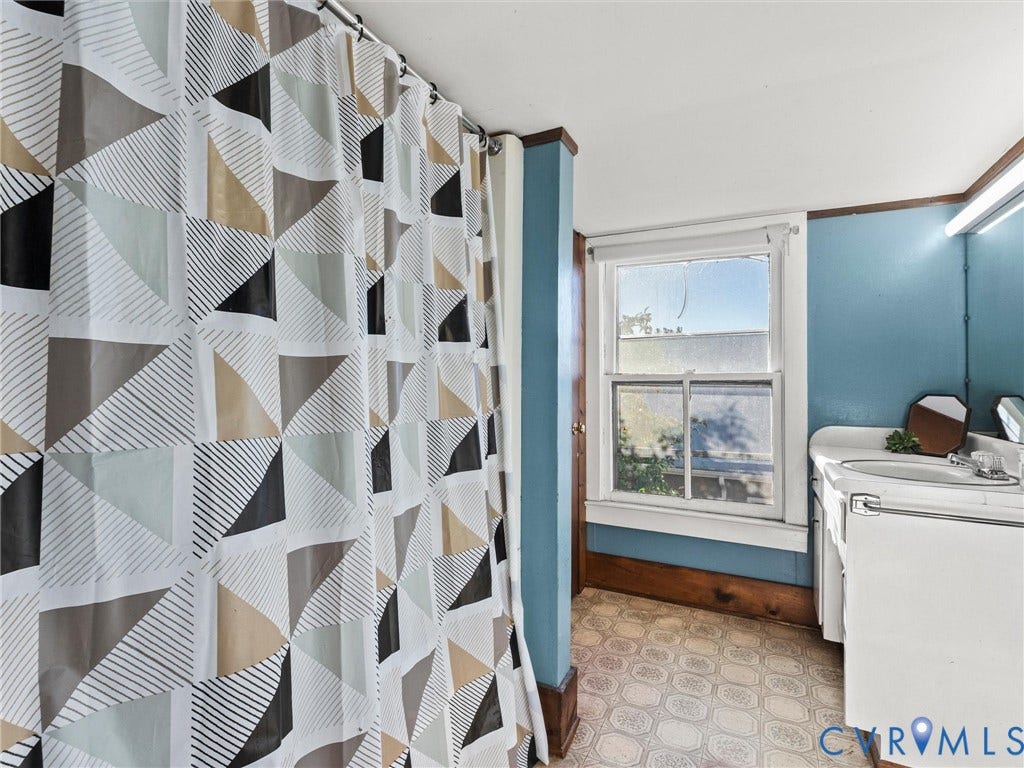 124 Suffolk Avenue, Chesterfield Highlands, Colonial Heights, VA 23834 Bathroom featuring a white vanity cabinet, tub/shower combo, patterned sheet vinyl flooring, a single-hung window with wood trim