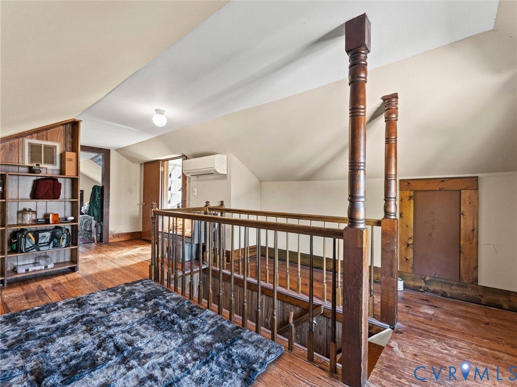 124 Suffolk Avenue, Chesterfield Highlands, Colonial Heights, VA 23834 Vaulted ceiling with hardwood flooring, built-in wooden shelving, and ornate wooden stair railing