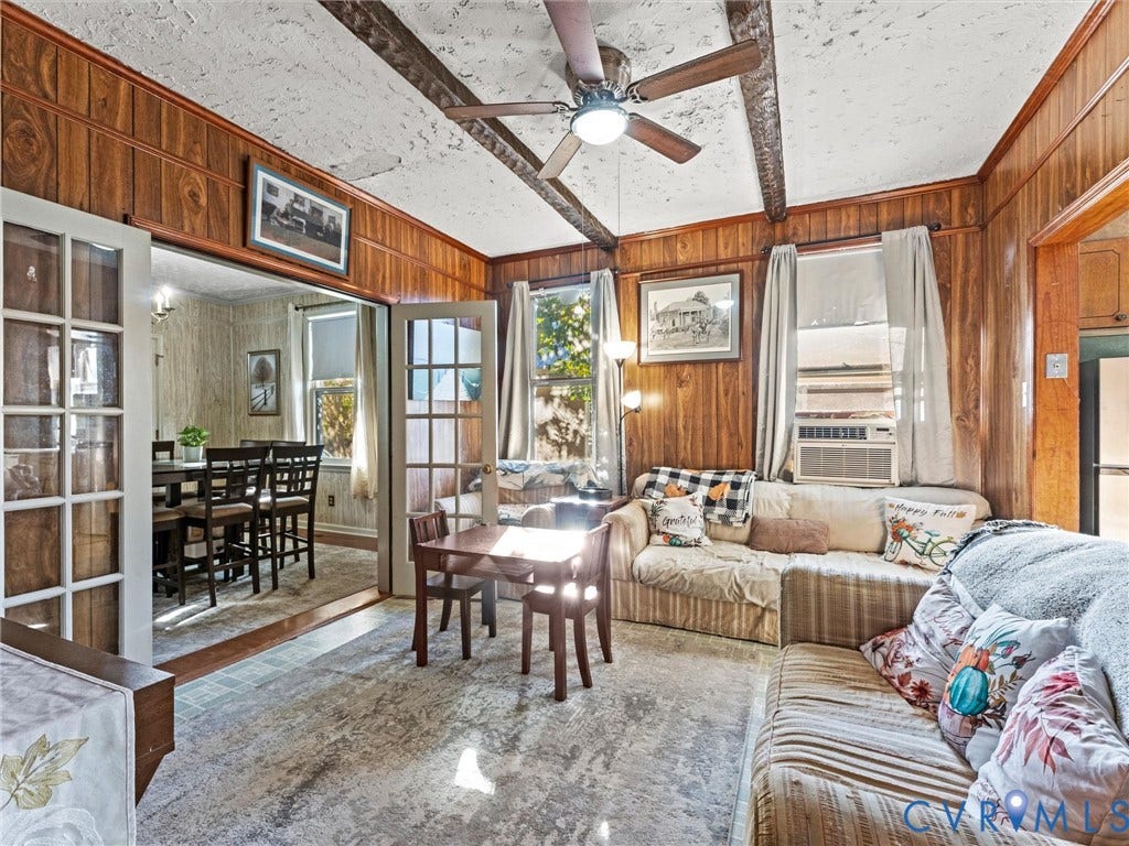124 Suffolk Avenue, Chesterfield Highlands, Colonial Heights, VA 23834 Living area featuring wood-paneled wall finish, exposed ceiling beams, multi-pane glass French doors, and ceiling fan with integrated lighting