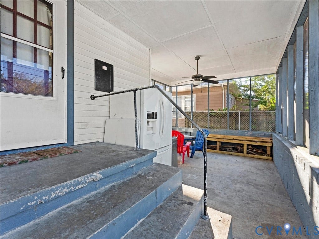 124 Suffolk Avenue, Chesterfield Highlands, Colonial Heights, VA 23834 Screened-in porch featuring concrete flooring, painted masonry walls, built-in wooden shelving, and a ceiling-mounted fan
