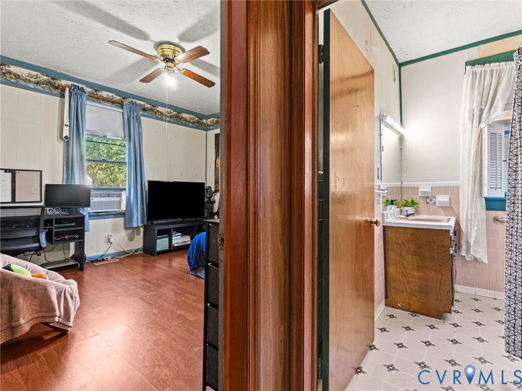 124 Suffolk Avenue, Chesterfield Highlands, Colonial Heights, VA 23834 Wood-finish flooring, ceiling fan, solid wood door, built-in bathroom vanity, and vinyl floor