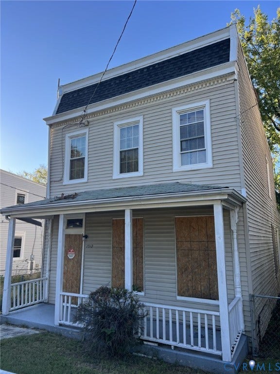 1512 N 23rd Street, Church Hill, Richmond, VA 23223 Two-story exterior featuring light-toned horizontal siding, a mansard-style roofline with decorative trim, and a covered front porch with a white wooden railing
