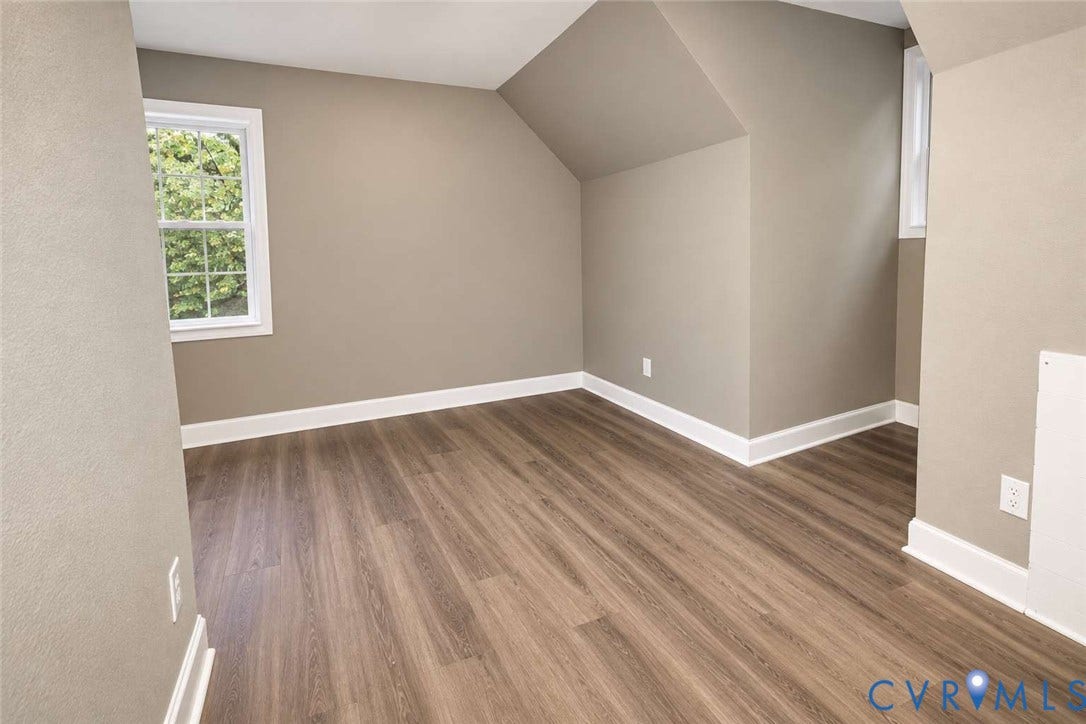 7300 Key Deer Court, Deer Run, Midlothian, VA 23112 Room featuring wood-finish flooring, neutral wall paint, and multi-pane windows with architectural angled ceiling detail
