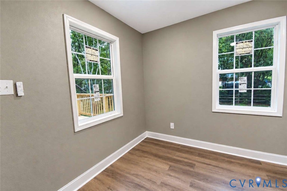 7300 Key Deer Court, Deer Run, Midlothian, VA 23112 Neutral-toned wall paint, wood-finish flooring, and dual double-hung windows with grid detailing